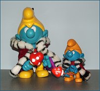 Large and smaller fake vinyl king smurfs.